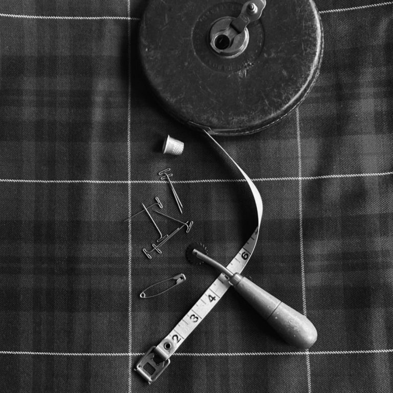 Traditional kilt with sewing accessories representing professional alteration and mail-in service across Scotland and UK