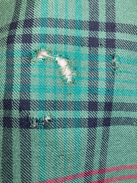 Before repair - visible moth holes in kilt fabric, Motherwell
